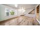 Bright living room featuring hardwood floors, large windows, and an inviting front entrance at 6810 E Appleton Ct, Centennial, CO 80112