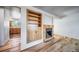 Inviting living room featuring hardwood floors, fireplace, and built-in shelving for both style and functionality at 6810 E Appleton Ct, Centennial, CO 80112