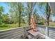 Charming patio area with an umbrella-covered table overlooking a serene green space with mature trees at 6810 E Appleton Ct, Centennial, CO 80112
