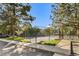 A fenced tennis court surrounded by trees is a featured amenity in this neighborhood at 6810 E Appleton Ct, Centennial, CO 80112