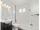 Updated bathroom with white subway tiles, a bathtub, and a dark vanity at 17769 E Purdue Pl, Aurora, CO 80013