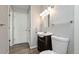 Bathroom with a pedestal sink, toilet and door to another room at 17769 E Purdue Pl, Aurora, CO 80013