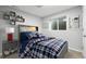 Basement bedroom with a plaid comforter and built-in shelving at 17769 E Purdue Pl, Aurora, CO 80013