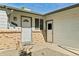 Gray front door with brick facade and side door entry at 17769 E Purdue Pl, Aurora, CO 80013