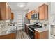 Modern kitchen featuring granite countertops and wood cabinets at 17769 E Purdue Pl, Aurora, CO 80013