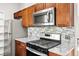 Stainless steel appliances and wood cabinets in kitchen at 17769 E Purdue Pl, Aurora, CO 80013