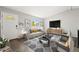 Living room featuring a gray sofa and flat-screen TV at 17769 E Purdue Pl, Aurora, CO 80013