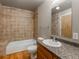 Bathroom featuring bathtub, shower, tile accents, and granite vanity at 1301 Wazee St # 2D, Denver, CO 80204