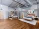 Bright bedroom with hardwood floors featuring two beds, and an attached workspace at 1301 Wazee St # 2D, Denver, CO 80204