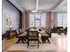 Open dining area with modern table set, exposed brick walls, and abundant natural light at 1301 Wazee St # 2D, Denver, CO 80204