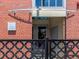 Charming brick building featuring the Left Bank Lofts entrance and secure ornamental iron fencing at 1301 Wazee St # 2D, Denver, CO 80204