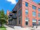 Brick condo building featuring iron balconies and large windows at 1301 Wazee St # 2D, Denver, CO 80204