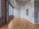 Spacious living room with exposed brick wall and hardwood floors at 1301 Wazee St # 2D, Denver, CO 80204