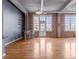 Spacious living room with hardwood floors and exposed brick walls at 1301 Wazee St # 2D, Denver, CO 80204