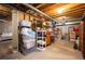 An unfinished basement is used for storage, revealing a view into another part of the basement, creating a sense of openness at 1073 Roslyn Ct, Denver, CO 80230