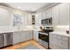 Bright kitchen with stainless steel appliances, and stone countertops at 1073 Roslyn Ct, Denver, CO 80230