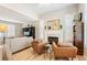 Bright living room featuring hardwood floors, fireplace, and stylish armchairs at 1073 Roslyn Ct, Denver, CO 80230