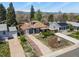 Aerial view of a well-maintained home with a detached garage, landscaping, and mountain views at 3941 S Elati St, Englewood, CO 80110