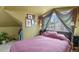 Attic bedroom featuring charming details, a slanted ceiling, and a cozy atmosphere at 3941 S Elati St, Englewood, CO 80110