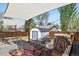 Backyard patio featuring a shade sail, hammock, string lights, and a convenient storage shed at 3941 S Elati St, Englewood, CO 80110