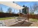 Backyard featuring a shade sail, hammock, mature trees, and a swing set at 3941 S Elati St, Englewood, CO 80110