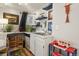 Home bar area featuring white cabinets, playful decor, and a stainless steel sink at 3941 S Elati St, Englewood, CO 80110