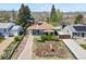 Charming single-Gathering home with mature landscaping, a long driveway, and mountain views at 3941 S Elati St, Englewood, CO 80110