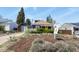Inviting property with mature landscaping and a bright yellow front door at 3941 S Elati St, Englewood, CO 80110