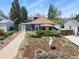 Charming home featuring mature landscaping and a bright yellow front door at 3941 S Elati St, Englewood, CO 80110
