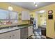 Bright kitchen featuring a gas range, stainless steel dishwasher and ample cabinets at 3941 S Elati St, Englewood, CO 80110