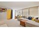 Comfortable living room featuring a large sectional sofa, plush carpeting, and bright natural light at 3941 S Elati St, Englewood, CO 80110