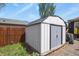 Metal backyard storage shed with a side yard view and mature landscaping at 3941 S Elati St, Englewood, CO 80110