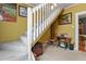Stairway decorated with antique sewing table, trunk and vintage art at 3941 S Elati St, Englewood, CO 80110