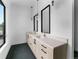 Modern bathroom with dual vanities, stylish mirrors, and herringbone tile flooring at 5258 Lions Paw St, Castle Rock, CO 80104