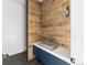 Modern bathroom with wood paneling, unique sink, and stylish lighting at 5258 Lions Paw St, Castle Rock, CO 80104
