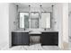 Contemporary bathroom featuring double vanity, sleek mirrors, and modern fixtures at 5258 Lions Paw St, Castle Rock, CO 80104