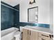 Bathroom boasting blue tiled walls, modern vanity, and white marble countertop and flooring accents at 5258 Lions Paw St, Castle Rock, CO 80104