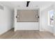 Neutral bedroom design featuring hardwood floors and decorative wall with lighting fixtures at 5258 Lions Paw St, Castle Rock, CO 80104