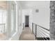 Bright upstairs hallway with white walls, hardwood floors, and modern railings at 5258 Lions Paw St, Castle Rock, CO 80104