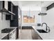 Modern kitchen with stainless steel appliances, a large island, and a seamless flow to the dining area at 5258 Lions Paw St, Castle Rock, CO 80104