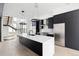 Elegant kitchen featuring a spacious island, stainless steel appliances, and modern lighting fixtures at 5258 Lions Paw St, Castle Rock, CO 80104