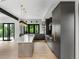 This open kitchen boasts gray cabinetry, an oversized island, designer lighting, and modern appliances at 5258 Lions Paw St, Castle Rock, CO 80104