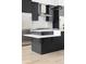 Close-up of a kitchen island with an overhang, white countertops, black cabinets, and stainless steel appliances at 5258 Lions Paw St, Castle Rock, CO 80104