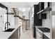 Modern kitchen with sleek countertops, stainless steel appliances, and an open staircase leading to the second floor at 5258 Lions Paw St, Castle Rock, CO 80104
