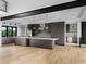 The modern kitchen is equipped with stainless steel appliances, designer lighting, and a large center island at 5258 Lions Paw St, Castle Rock, CO 80104
