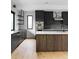 Modern kitchen featuring dark cabinets, stainless steel appliances, and a wooden island with a white countertop at 5258 Lions Paw St, Castle Rock, CO 80104