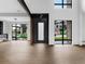 The sun-filled living room showcases expansive windows, wood floors, and modern finishes at 5258 Lions Paw St, Castle Rock, CO 80104