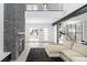 Bright living room with a stone fireplace, open staircase, and a comfortable sectional sofa at 5258 Lions Paw St, Castle Rock, CO 80104