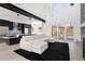 Spacious living room with a modern kitchen, large sectional sofa, fireplace, and sliding glass doors at 5258 Lions Paw St, Castle Rock, CO 80104