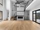 Bright, open-concept living room features a modern fireplace, hardwood floors, and an open staircase to the upper level at 5258 Lions Paw St, Castle Rock, CO 80104